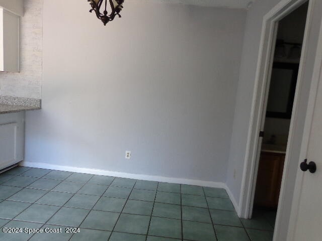 unfurnished dining area with light tile patterned floors