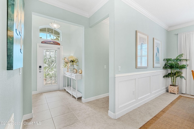 tiled foyer entrance featuring crown molding