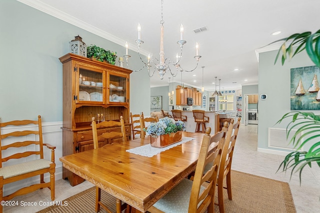 dining space featuring crown molding and a chandelier