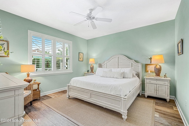 bedroom with ceiling fan and hardwood / wood-style floors