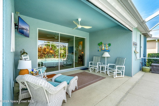 view of patio / terrace with ceiling fan and a lanai