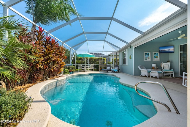 view of pool with a patio, pool water feature, a lanai, and ceiling fan