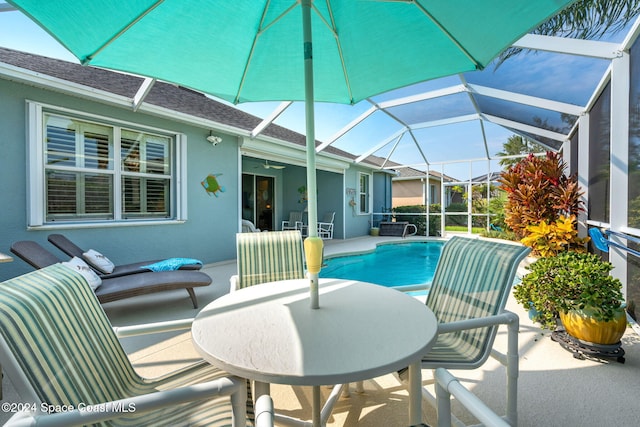 view of swimming pool with a patio area and glass enclosure