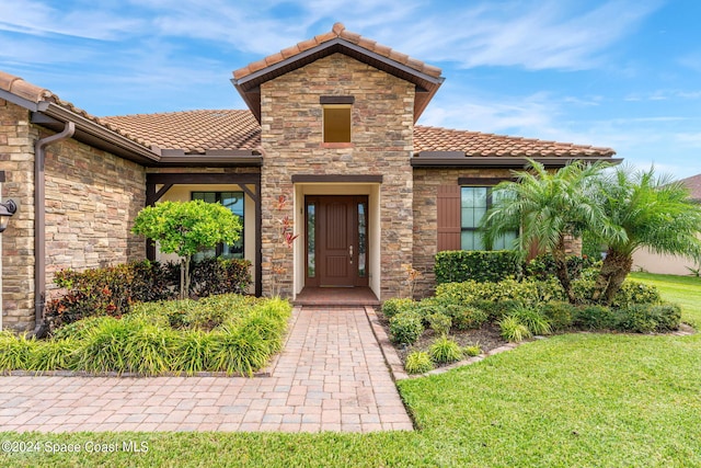 property entrance with a yard