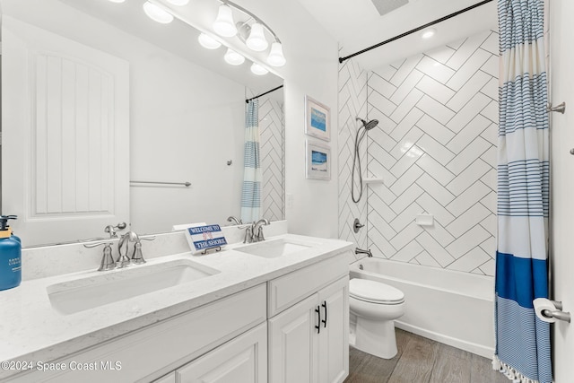 full bathroom with vanity, toilet, wood-type flooring, and shower / tub combo