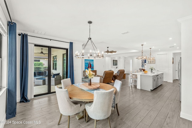 dining room with ceiling fan, light hardwood / wood-style flooring, and crown molding