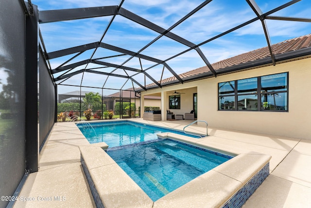 view of swimming pool with an outdoor hangout area, ceiling fan, a lanai, an in ground hot tub, and a patio area