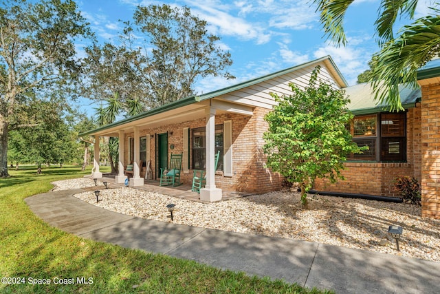 back of house featuring a porch