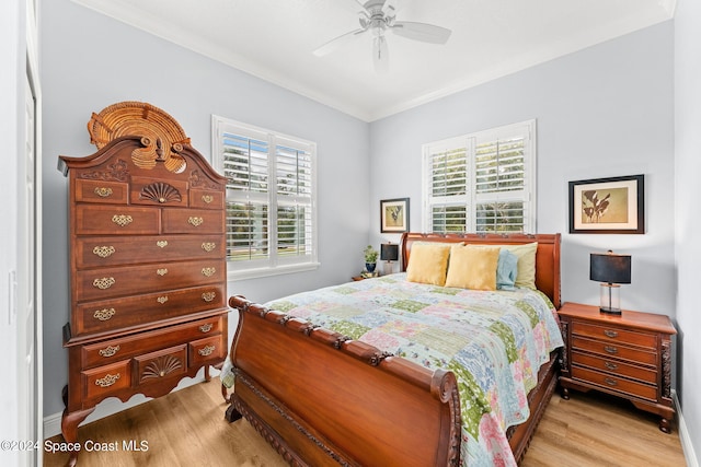 bedroom with ceiling fan, crown molding, and light hardwood / wood-style flooring