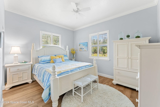 bedroom featuring ornamental molding, wood-type flooring, and ceiling fan