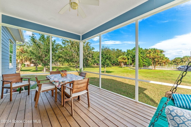 sunroom / solarium featuring ceiling fan