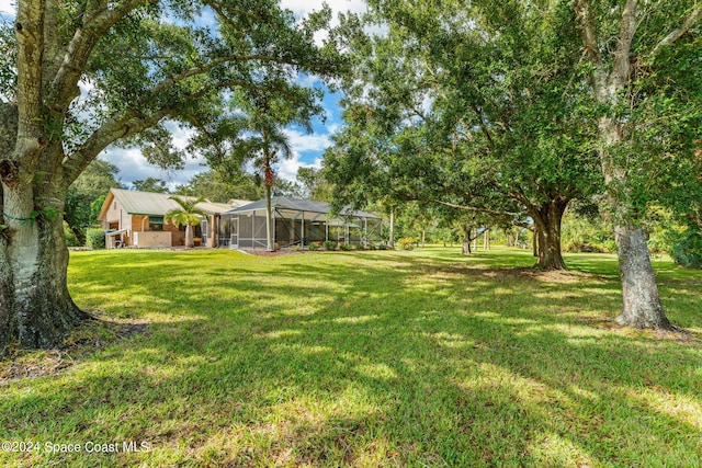 view of yard featuring glass enclosure