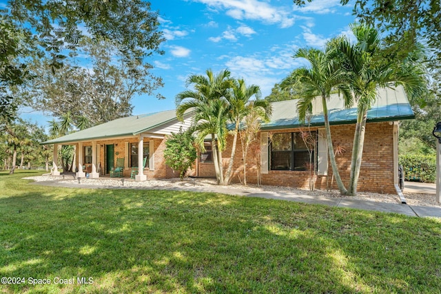 rear view of property featuring a yard