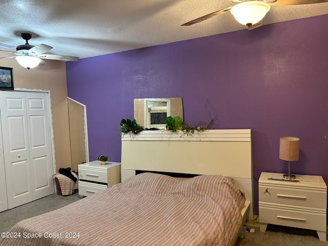 bedroom with ceiling fan, a textured ceiling, and dark colored carpet