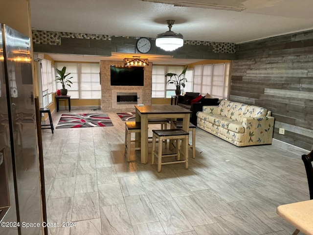 dining room featuring a fireplace and plenty of natural light