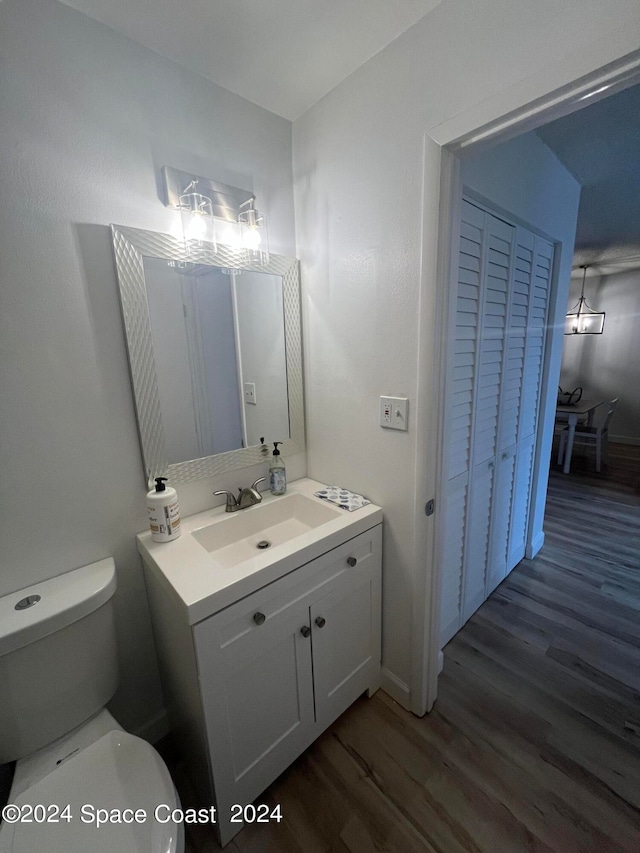 bathroom featuring vanity, toilet, and hardwood / wood-style flooring