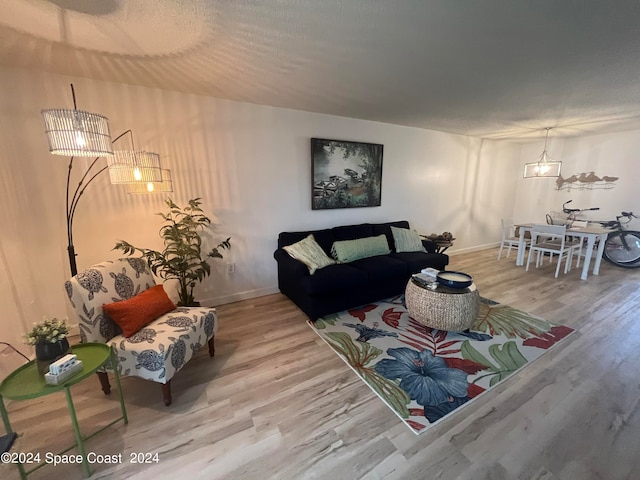 living room featuring hardwood / wood-style floors and a chandelier