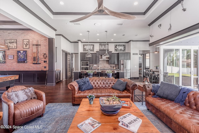 living room with crown molding, a raised ceiling, ceiling fan, and dark hardwood / wood-style flooring