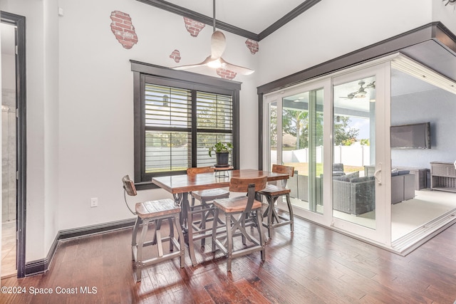 dining area featuring crown molding, plenty of natural light, and dark hardwood / wood-style flooring