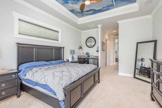 bedroom with ceiling fan, crown molding, a tray ceiling, and light hardwood / wood-style floors