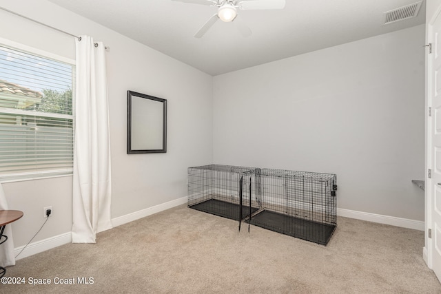 unfurnished room with ceiling fan and light colored carpet