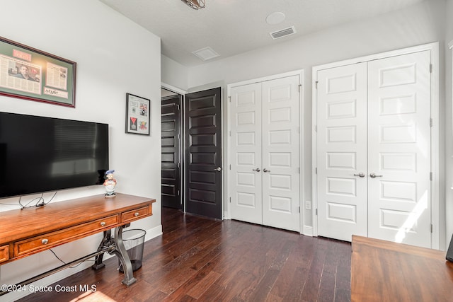 home office featuring a textured ceiling and dark hardwood / wood-style floors