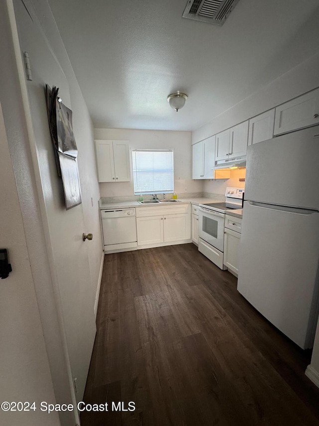 kitchen featuring white appliances, white cabinetry, dark hardwood / wood-style flooring, and sink