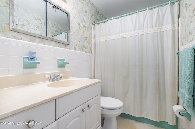 bathroom featuring vanity, a shower with shower curtain, tile walls, and toilet