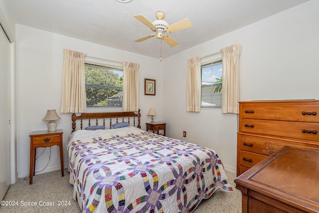 bedroom with multiple windows and ceiling fan