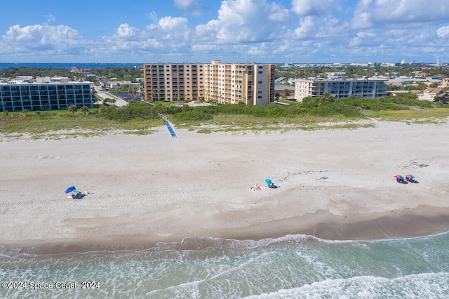 drone / aerial view with a water view and a beach view