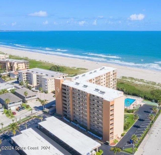 bird's eye view with a water view and a beach view