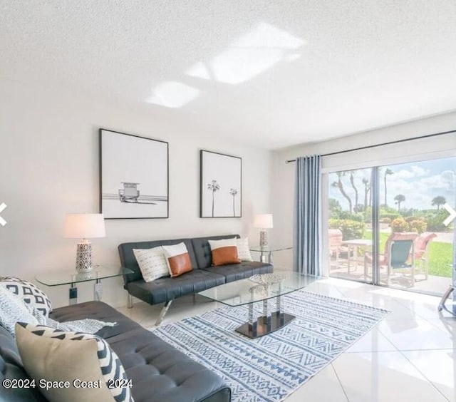 tiled living room featuring a textured ceiling