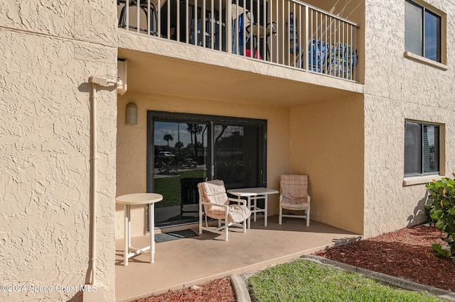 view of patio featuring a balcony