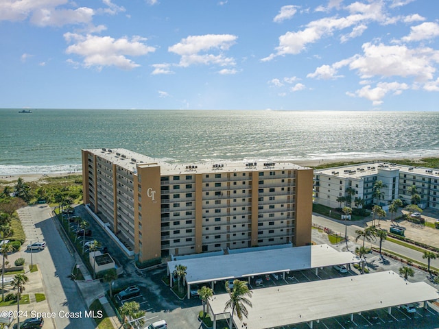 birds eye view of property with a water view and a view of the beach