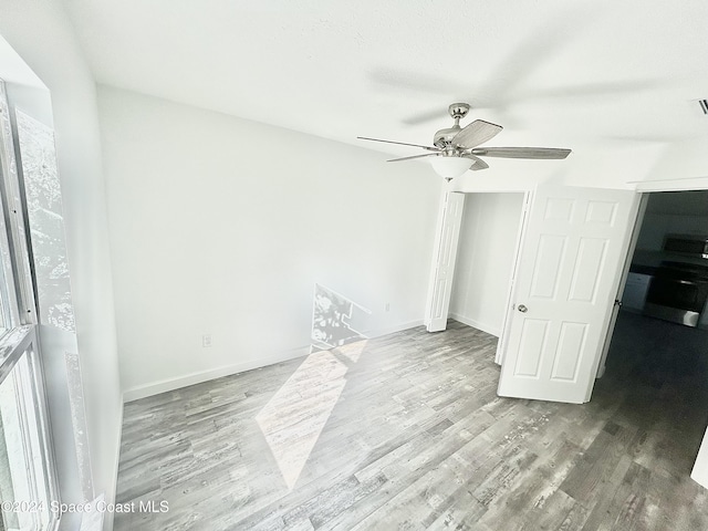 unfurnished bedroom featuring ceiling fan and light hardwood / wood-style floors