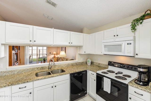 kitchen featuring sink, white cabinets, a textured ceiling, and white appliances