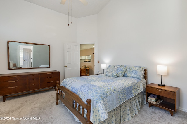 carpeted bedroom featuring ceiling fan and high vaulted ceiling