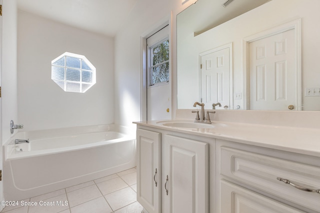 bathroom featuring vanity, a bath, and tile patterned flooring