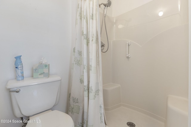 bathroom with a shower with curtain and toilet