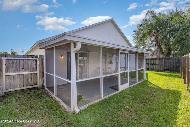 exterior space with a lawn and a sunroom