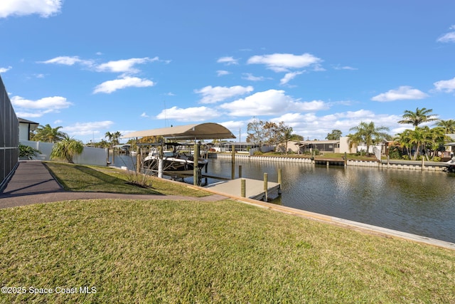 view of dock featuring a water view and a lawn