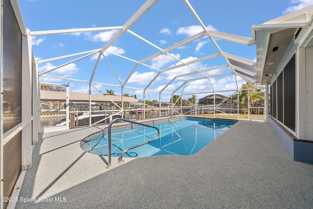 view of swimming pool with a patio, a water view, a boat dock, and glass enclosure