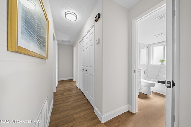 hallway with dark hardwood / wood-style floors