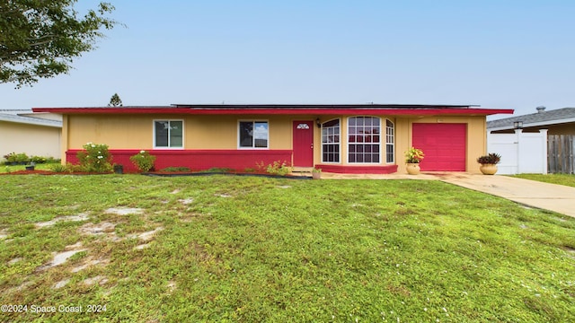 single story home with a front yard and a garage