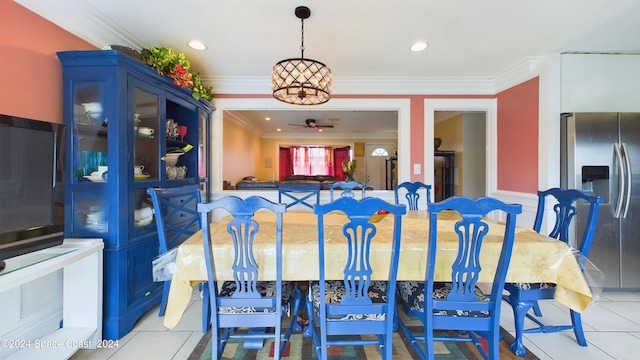 tiled dining area featuring ornamental molding and ceiling fan with notable chandelier