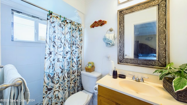 bathroom featuring vanity, toilet, and a shower with curtain