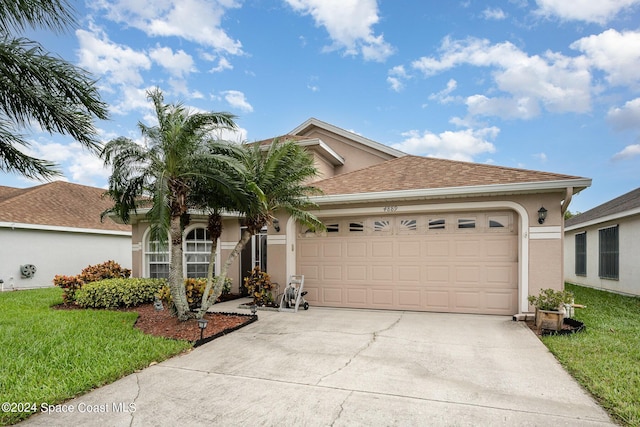 4889 Worthington Cir, Rockledge, FL 32955 - single story home with an attached garage, stucco siding, driveway, and a front lawn