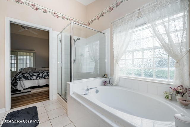 4889 Worthington Cir, Rockledge, FL 32955 - bathroom with ensuite bath, ceiling fan, a shower stall, tile patterned floors, and a garden tub