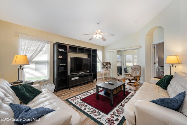 4889 Worthington Cir, Rockledge, FL 32955 - living area featuring lofted ceiling, light wood-style floors, ceiling fan, and arched walkways