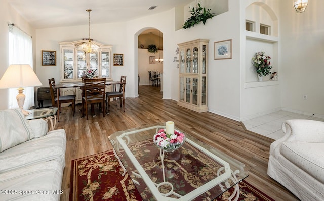 4889 Worthington Cir, Rockledge, FL 32955 - living area with baseboards, arched walkways, light wood-type flooring, and visible vents